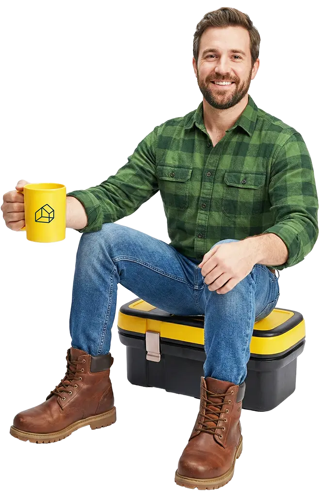 Man sitting on toolbox with a coffee, ready for a chat about FitterPal
